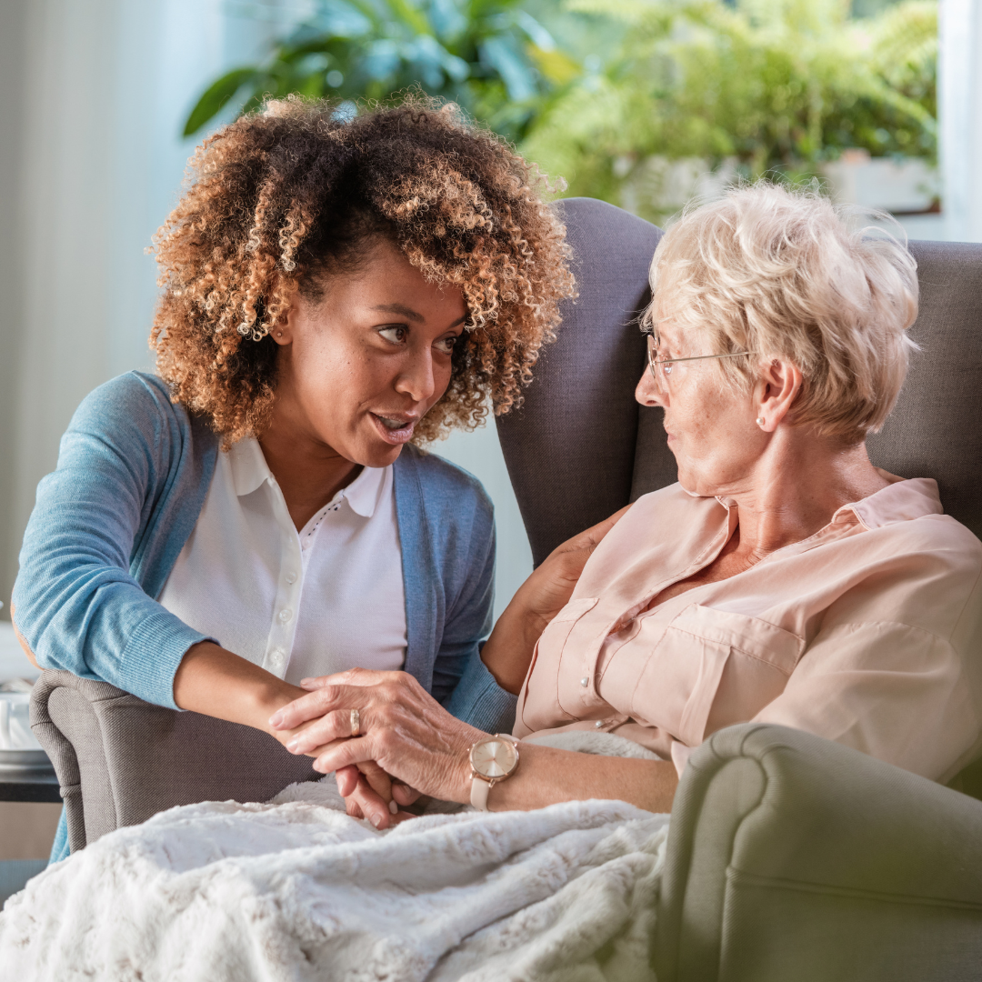 woman comforting older woman in house